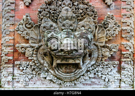 Traditional Indonesian totem of a sacred creature on the wall of the ancient Ubud palace. Bali, Indonesia. Stock Photo