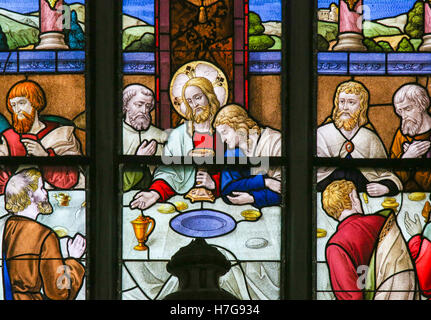 Stained Glass window depicting Jesus offering communion to His Apostles at the Last Supper, in the Cathedral of Saint Rumbold in Stock Photo