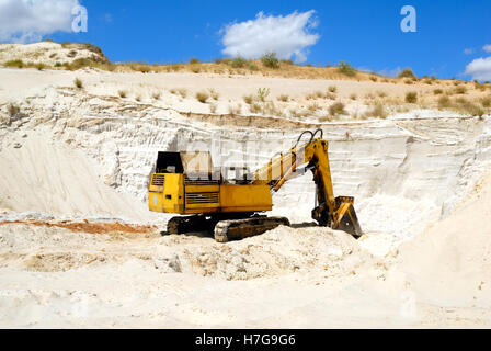 Old yellow dredge in sandy to career Stock Photo