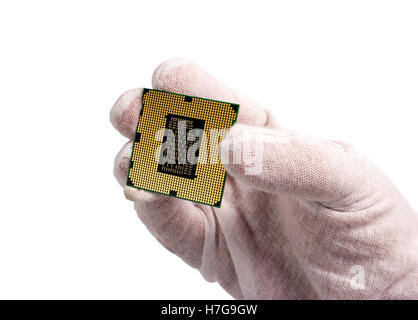Electronic collection - Computer processor from the bottom side in male hand isolated on white background Stock Photo