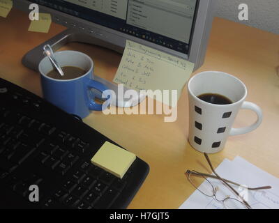 The activity 'Pair programming' in extreme programming and scrum illustrated by two coffee cups and a note with the pairs for sp Stock Photo