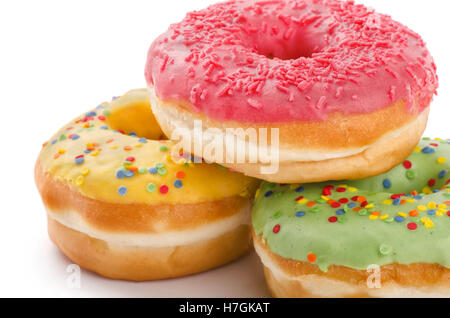 Three donuts with sprinkles isolated on white background Stock Photo