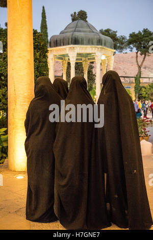 women in chador watching hafez tomb Stock Photo