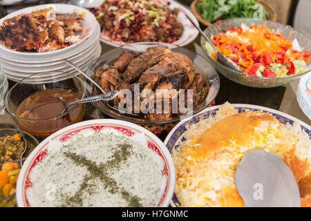 many dishes of a traditional iranian meal including chicken and rice Stock Photo