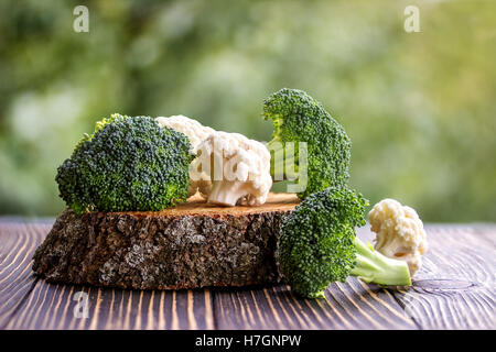 Still life with assortment cabbages on wooden background Stock Photo