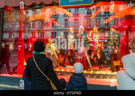 Paris, France, People Enjoying Christmas Lights, Decor, Store Window Displays, Jimmy Choo Shoes, SHopping, Le Printemps Department Store, Family from Behind Stock Photo