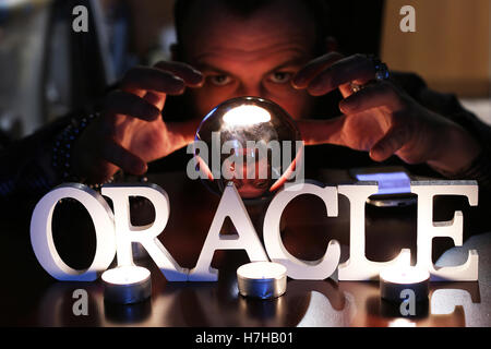 sorcerer hands over a transparent crystal ball fortune-telling for future Stock Photo