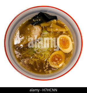 Japanese Shoyu soya sauce ramen noodles adorned with marinated bamboo shoots (menma), green onions, nori (seaweed), boiled eggs. Stock Photo