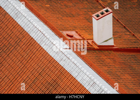Old style orange tiled roof and chimney closeup, from above view Stock Photo