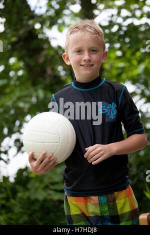 Young vital boy holding a volleyball. Clitherall Minnesota MN USA Stock Photo