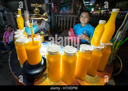 A woman selling food at Chiang Mai Walking Night Market, Thailand Stock Photo