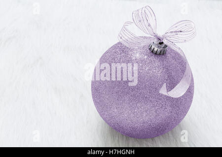 One beautiful, fancy,  perfect, sparkly, shiny, purple glitter Christmas ornament on horizontal white background Stock Photo