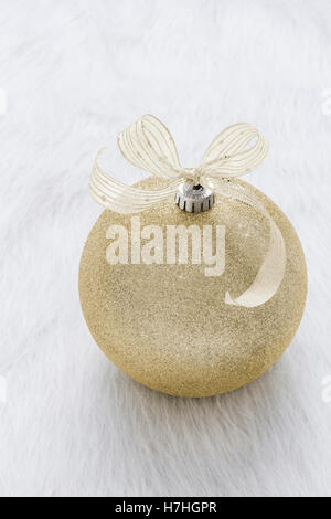 One beautiful, fancy,  perfect, sparkly, shiny, gold glitter Christmas ornament on vertical white background Stock Photo