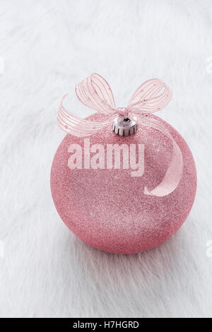 One beautiful, fancy,  perfect, sparkly, shiny, pink glitter Christmas ornament on vertical white background Stock Photo