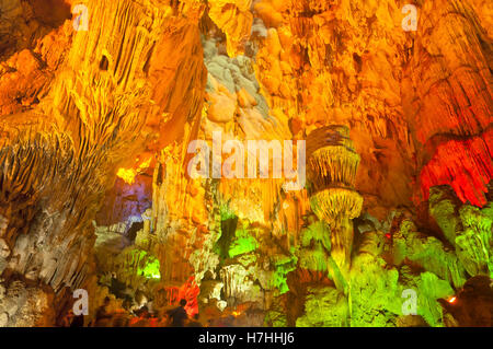 The stalagtites hanging down from the ceiling of a Dau Go cave under colored lights in HaLong bay, Vietnam. Stock Photo