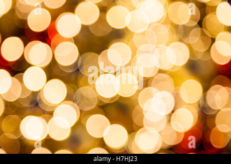 Blurred and defocused golden Christmas bokeh background lights. Stock Photo