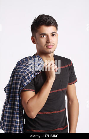 handsome man wearing tshirt hold shirt on top of his shoulder Stock Photo