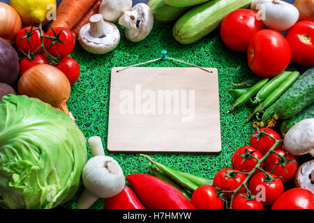 Fresh vegetables on a brown background with  paper Stock Photo