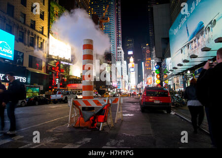 Con-Edison steam system stack venting vapour into the night on 7th Avenue, Manhattan, New York Stock Photo