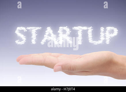 Startup hovering clouds over a hand Stock Photo