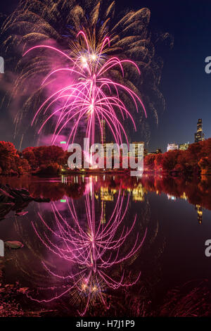 Central Park Fireworks celebrating the Marathon reflecting on the Lake. Midtown Manhattan, New York City Stock Photo