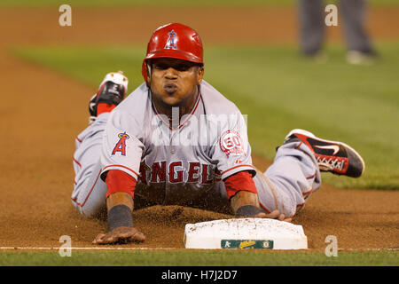 September 13, 2011; Oakland, CA, USA;  Los Angeles Angels shortstop Erick Aybar (2) slides into third base against the Oakland Athletics during the third inning at O.co Coliseum. Stock Photo