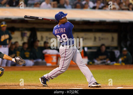 September 20, 2011; Oakland, CA, USA;  Texas Rangers third baseman Adrian Beltre (29) hits a three run home run against the Oakland Athletics during the first inning at O.co Coliseum. Stock Photo