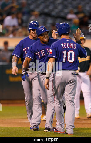 September 20, 2011; Oakland, CA, USA;  Texas Rangers third baseman Adrian Beltre (center) is congratulated by left fielder Josh Hamilton (back) and designated hitter Michael Young (10) after hitting a three run home run against the Oakland Athletics durin Stock Photo