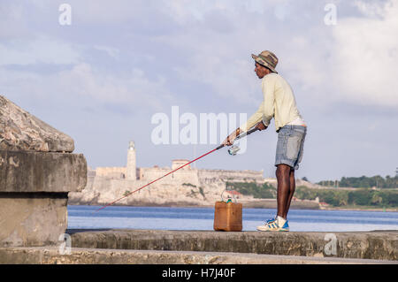 Cuban Fisherman with rod on Malecon in front of Castillo Stock Photo