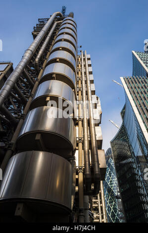 LONDON - NOVEMBER 3, 2016: The Lloyds Building and The Gherkin skyscrapers are joined by construction in the insurance quarter. Stock Photo