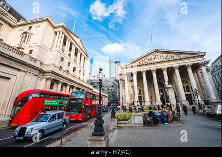 LONDON - NOVEMBER 3, 2016: Modern red double-decker bus passes in front of the Bank of England and Royal Exchange Stock Photo