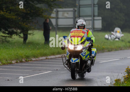 Motorcycle police officer clearing the way for the Tour of Britain Cycle Race entering Kendal in Cumbria Stock Photo