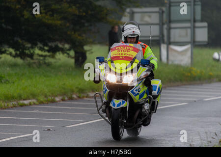 Motorcycle police officer clearing the way for the Tour of Britain Cycle Race entering Kendal in Cumbria Stock Photo