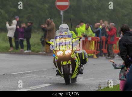 Motorcycle police officer clearing the way for the Tour of Britain Cycle Race entering Kendal in Cumbria Stock Photo