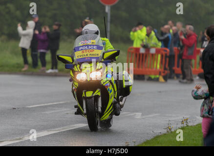 Motorcycle police officer clearing the way for the Tour of Britain Cycle Race entering Kendal in Cumbria Stock Photo