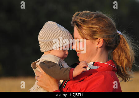 Happy mother and 6 month old baby boy smiling Stock Photo