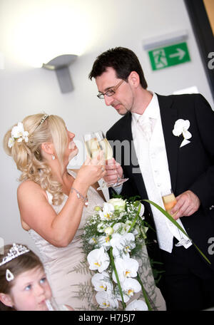 Bride and groom toasting with champagne glasses Stock Photo