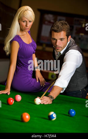 Man and woman playing billiard Stock Photo