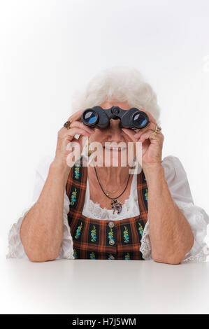 Elderly woman with a pair of binoculars Stock Photo