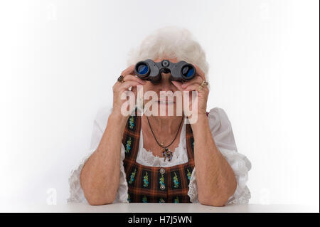 Elderly woman with a pair of binoculars Stock Photo