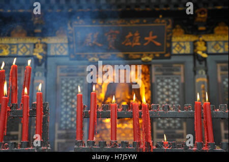 Candles in front of Buddha statue, China, Asia Stock Photo