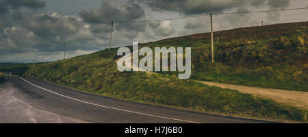 A country road winds it's way through a beautiful southern Irish countryside. Stock Photo