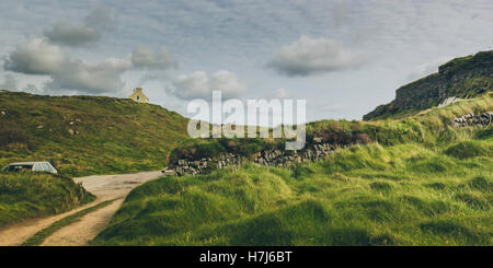 dirt tracks winding through a grassy knoll Stock Photo