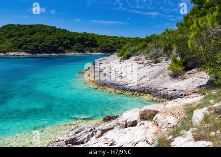 Rocky coast ofa a bay in the Pakleni islands. Paklinski otoci. Transparent Adriatic sea water. Croatia. Europe. Stock Photo