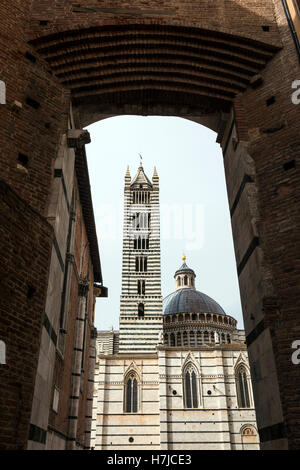 The Siena Duomo viewed through an ancient archway in Siena, Tuscany, Italy Stock Photo