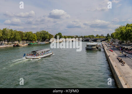 Tourist commercial boats going along the Seine river Paris France Stock Photo