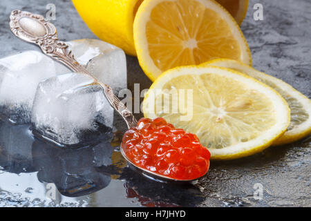 Red salmon caviar and lemon. Selective focus Stock Photo