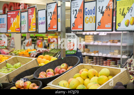 Harris Farm markets retail grocery store in North Sydney, mangoes and apples for sale on display Stock Photo