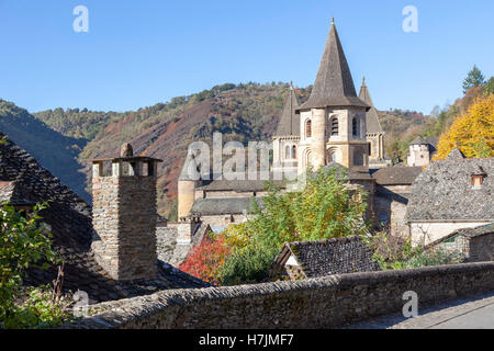 The small medieval village of Conques (France). It shows visitors its abbey-church and clustered houses topped by slate roofs.