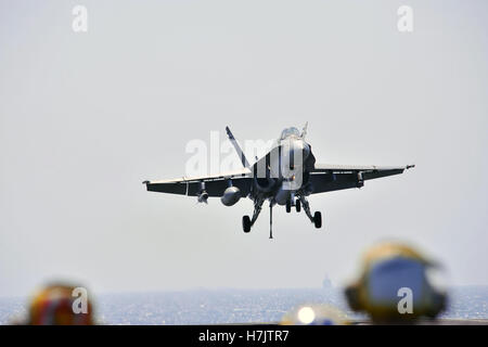 An F/A-18C Super Hornet aircraft prepares to land aboard the USN Nimitz-class aircraft carrier USS George H.W. Bush September 18, 2014 in the Persian Gulf. Stock Photo